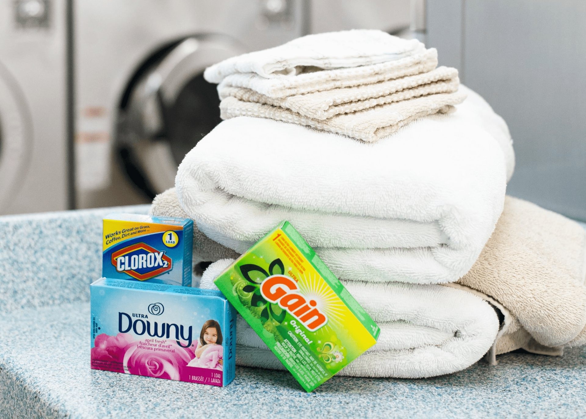 Folded towels and detergent on the folding counter